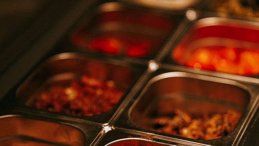 stainless steel buffet containers in cafeteria serving line