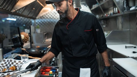 professional chef preparing food in a commercial kitchen