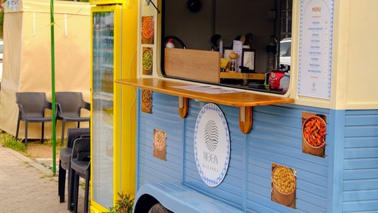 colorful food truck with serving window and counter