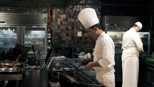 professional chefs preparing food in hotel kitchen