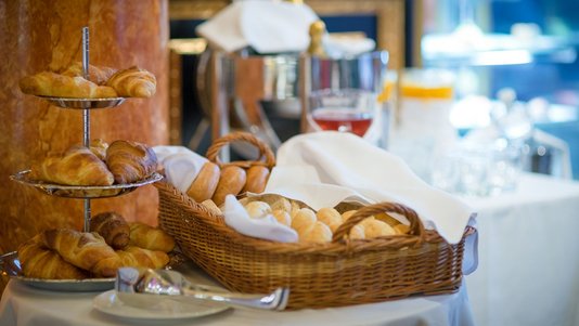 luxury hotel breakfast buffet with croissants and bread