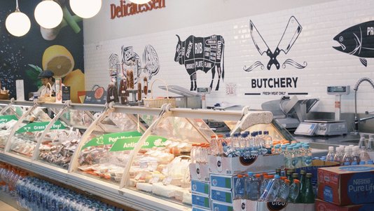 supermarket deli counter with prepared food display cases